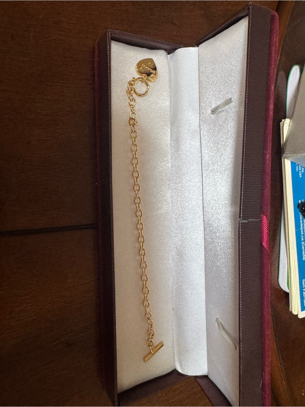 Coach heart gold bracelet features a polished gold-tone heart charm toggle
